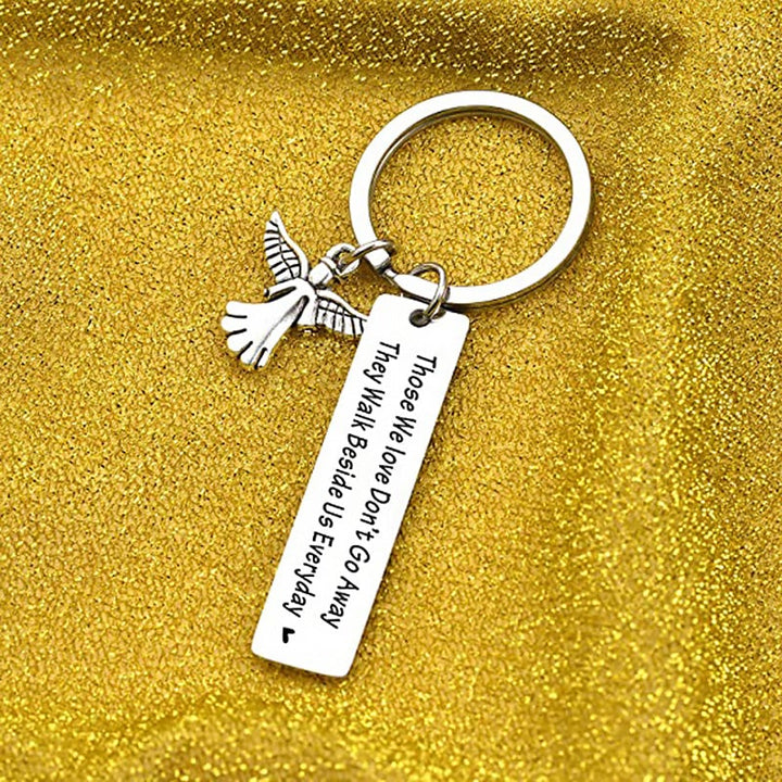 "Nyckelring med silverfärgade änglavingar och hjärta, spegelpolerat stål, elegant souvenir och minnesgåva."