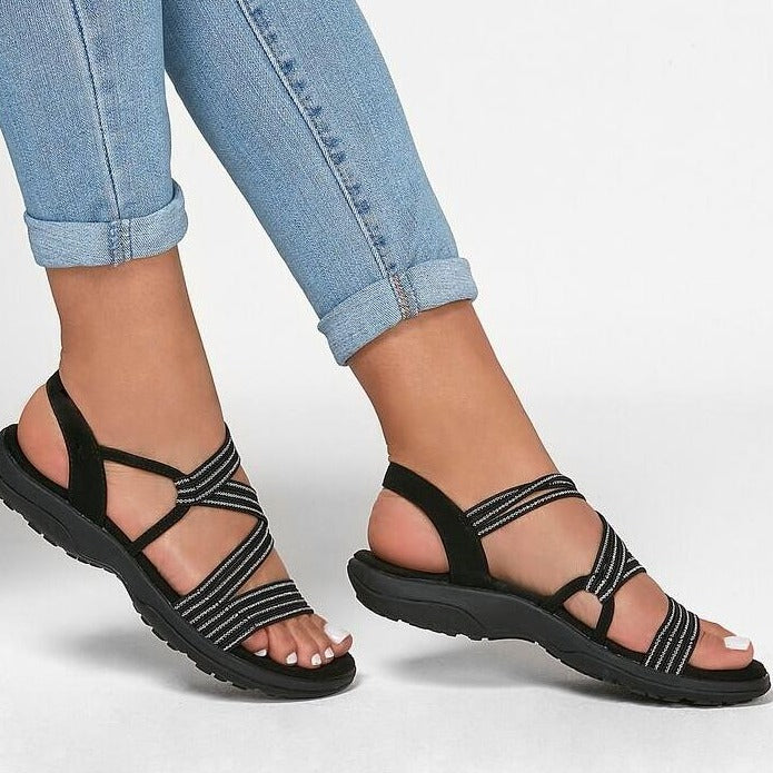"Ortopediska slip-on damsandaler med justerbara remmar, stödjande fotvalv och anatomisk fotbädd i elegant design."