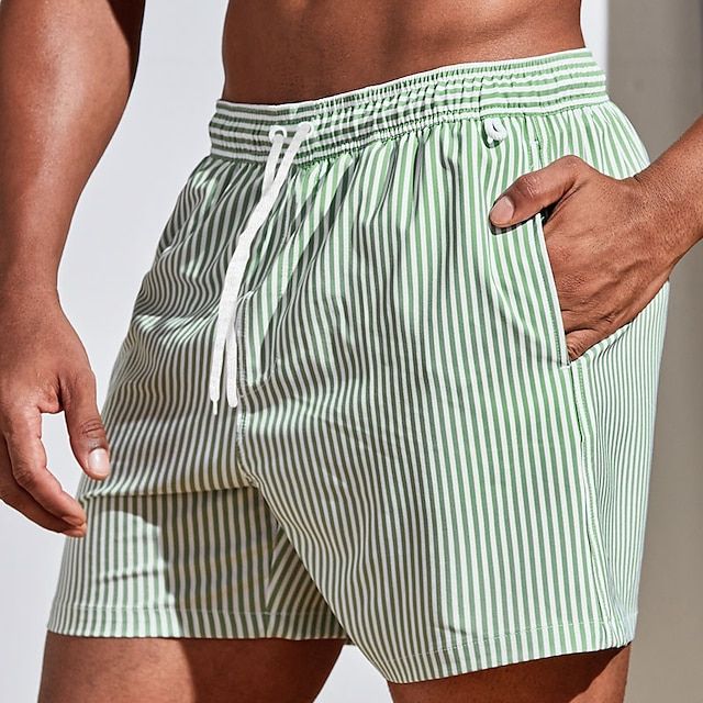"Randiga snabbtorkande badshorts herr i bomull, blå och ljusgrön, med elastisk midja för sommarens strandäventyr"