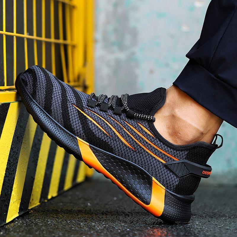 "Säkerhetsskor för män med ståltåhätta, mörk färg, halksäker sula, idealisk för arbetsmiljö, robust design."