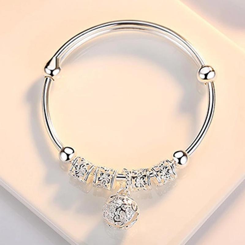 "Silvrigt justerbart armband för kvinnor med pärldetaljer, elegant blommönster, perfekt accessoar för alla smyckessamlingar."