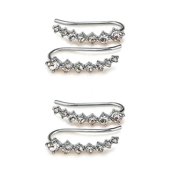 "Sju-stjärniga stiftörhängen med kristaller i guld, eleganta accessoarer för kvinnor, glänsande och sofistikerad design."