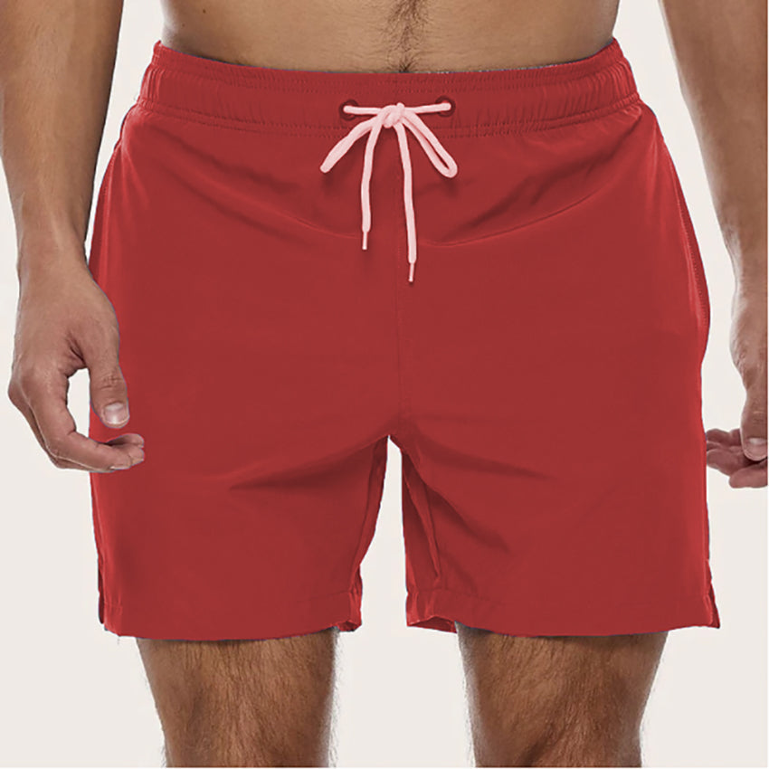 "Snabbtorkande badshorts i grått med ljusblå detaljer, elastisk midja och trendig design för män på sommaren."