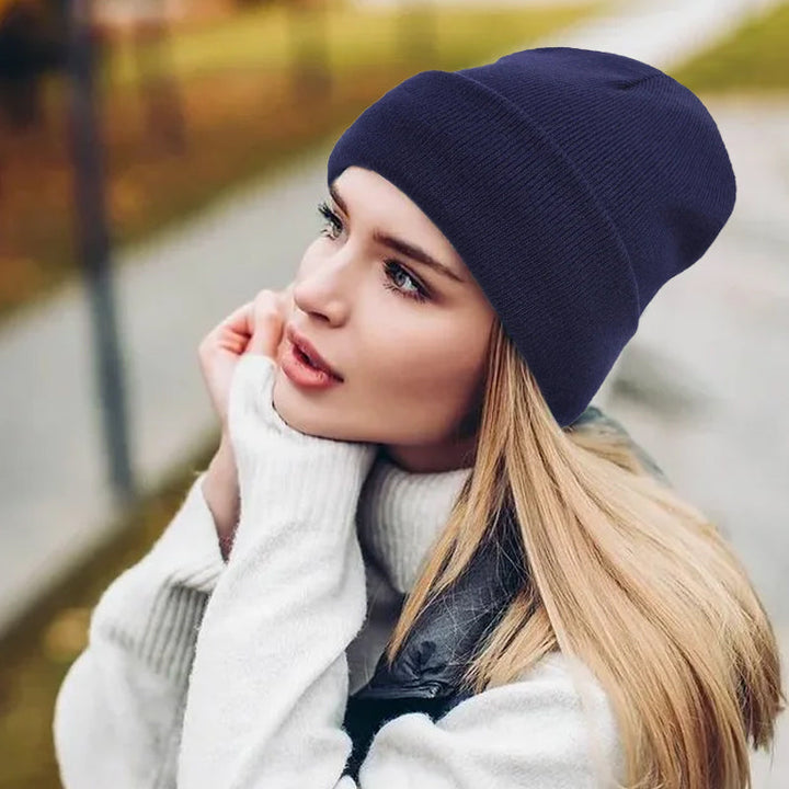 "Stickad dammössa med satinlining i blått, värmande material, modern design, erbjuder skydd och stil för kalla dagar."