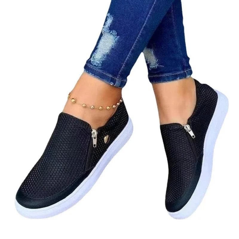 "Svarta mesh zip-up sneakers med vita flexibla sulor och sidodragkedja för enkel påtagning, perfekt kombination av stil och k