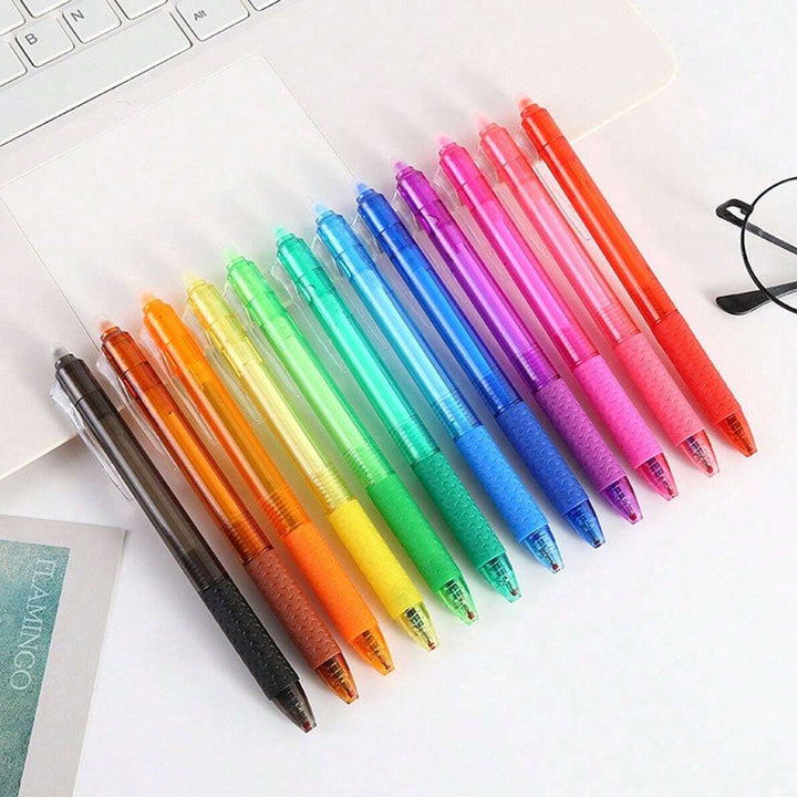"Top down view of colorful erasable gel pens on white background with visible pen tips and vibrant colors."