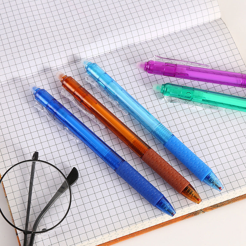 "Top down view of colorful erasable gel pens on white background with visible pen tips and vibrant colors."
