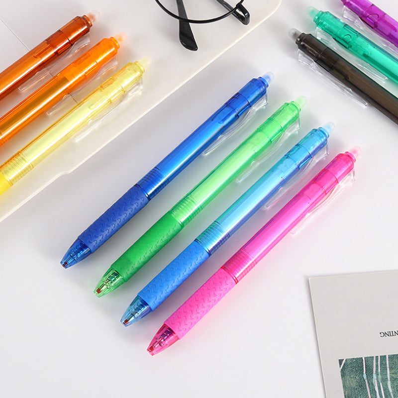 "Top down view of colorful erasable gel pens on white background with visible pen tips and vibrant colors."