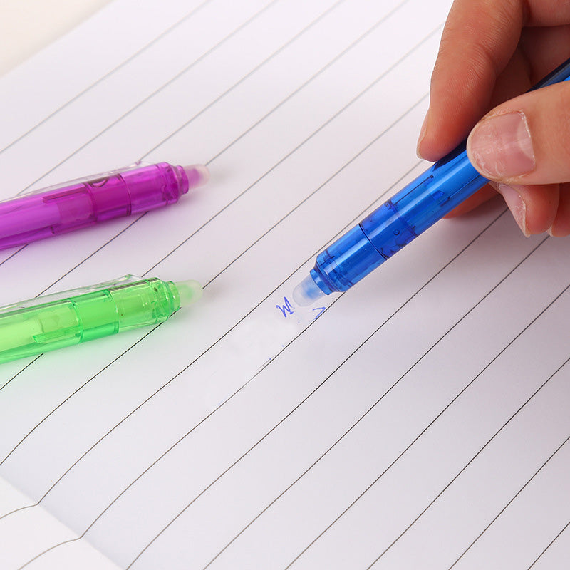 "Top down view of colorful erasable gel pens on white background with visible pen tips and vibrant colors."
