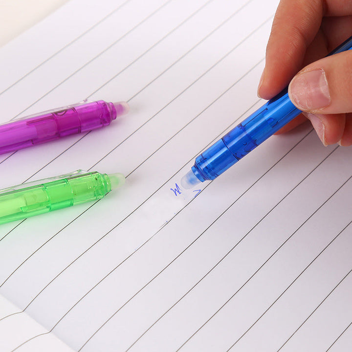 "Top down view of colorful erasable gel pens on white background with visible pen tips and vibrant colors."