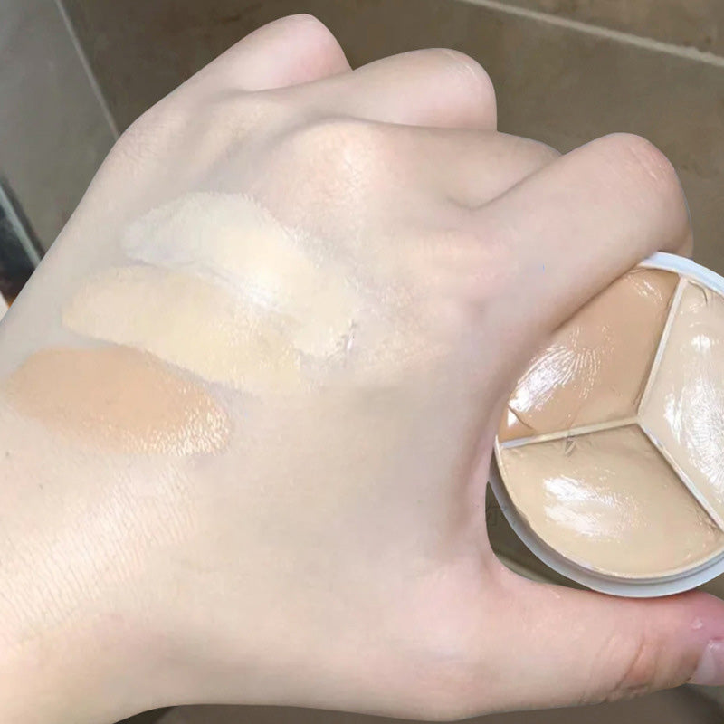 "Tri-Färg Concealer Palett med tre nyanser för alla hudtoner, kompakt design, visar mjuk och krämig textur."
