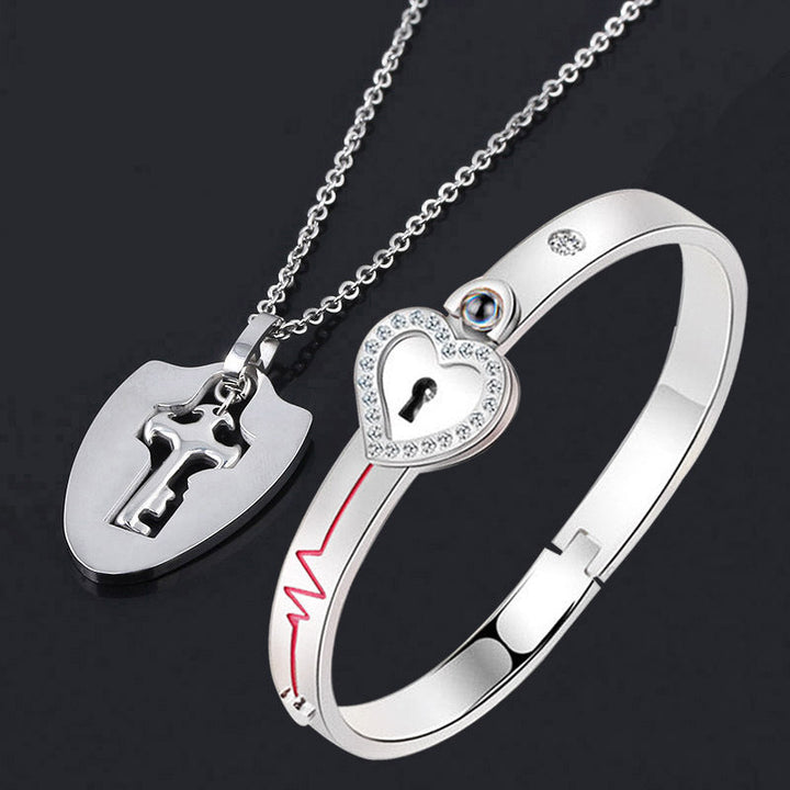 Unisex låsarmband och nyckelhalsband i titanstål, elegant design i stål och roséguld, stilfullt och hållbart smyckeset.
