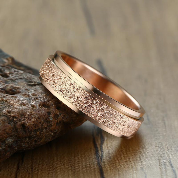 "Unisex sandblästrad roterande fidget ring i rostfritt stål, elegant och modern design, flera färger tillgängliga."
