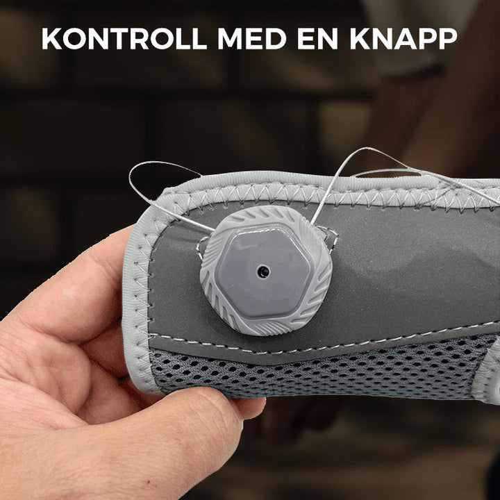 "Unisex vrist stödbandage i grå och svart för sport och träning, med justerbar passform och mikrofibertyg för stöd."
