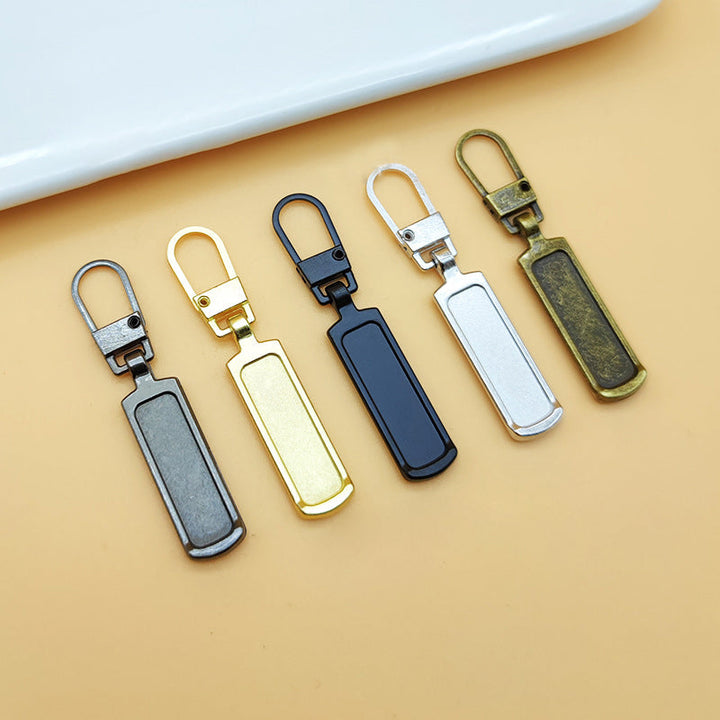 "Universalt avtagbart metallhandtag för dragkedjor, silver, perfekt för kläder och väskor, rektangulärt, robust design."