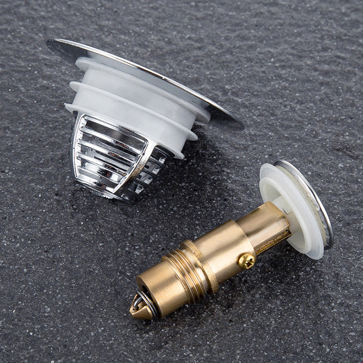 "Universell badrumsavloppspropp i elegant mässing och stål med tryckknapp, silikonringar för säker passform mot smuts."