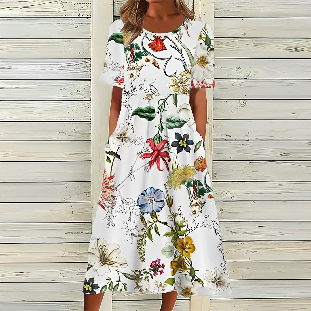 Vit sommarklänning med livfullt blommönster för kvinnor, avslappnad passform, idealisk för varma dagar och trädgårdsfester.